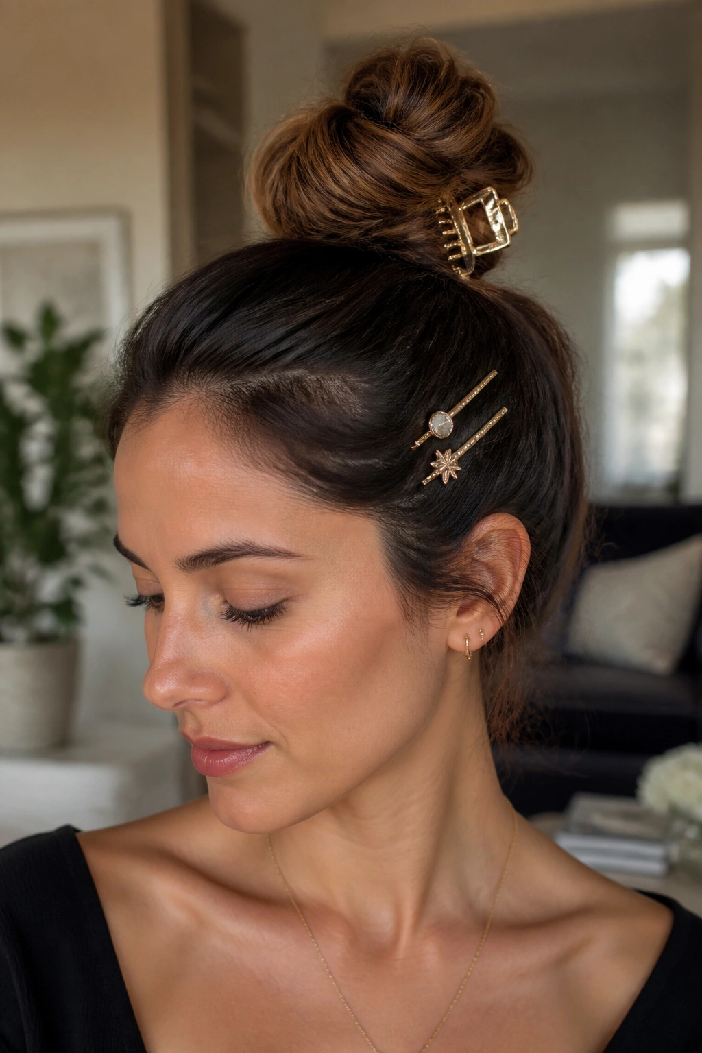 Close-up of a real woman wearing a top knot with decorative pins and a large clip.