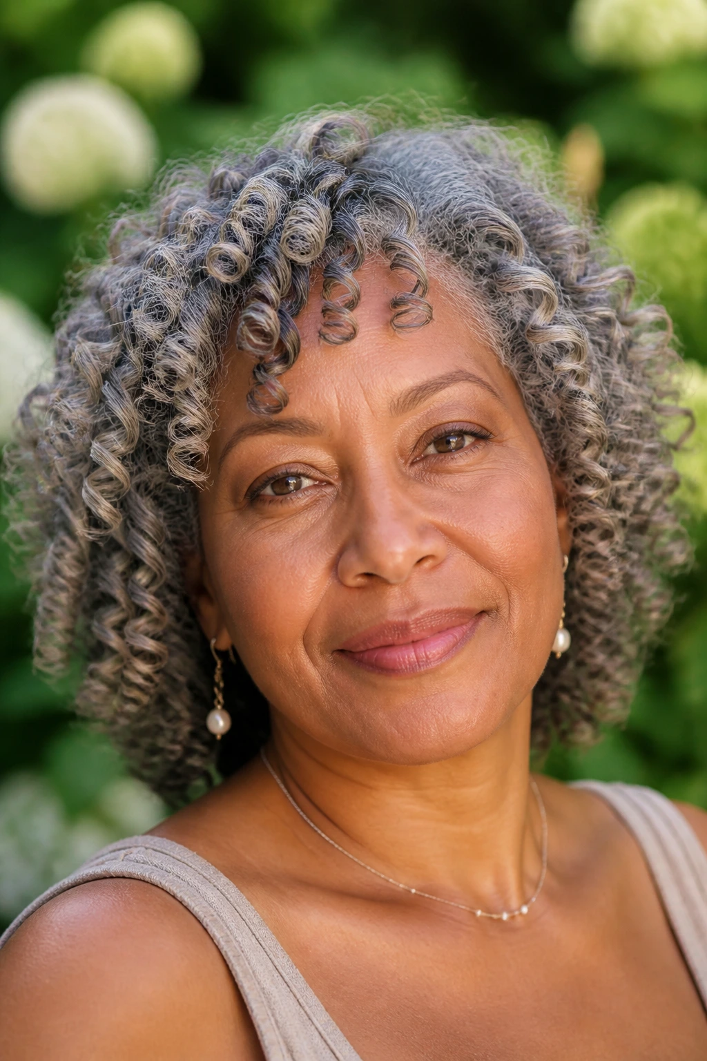 Close-up of a real woman with air-dried ringlets and gray hair, curls separated and defined.