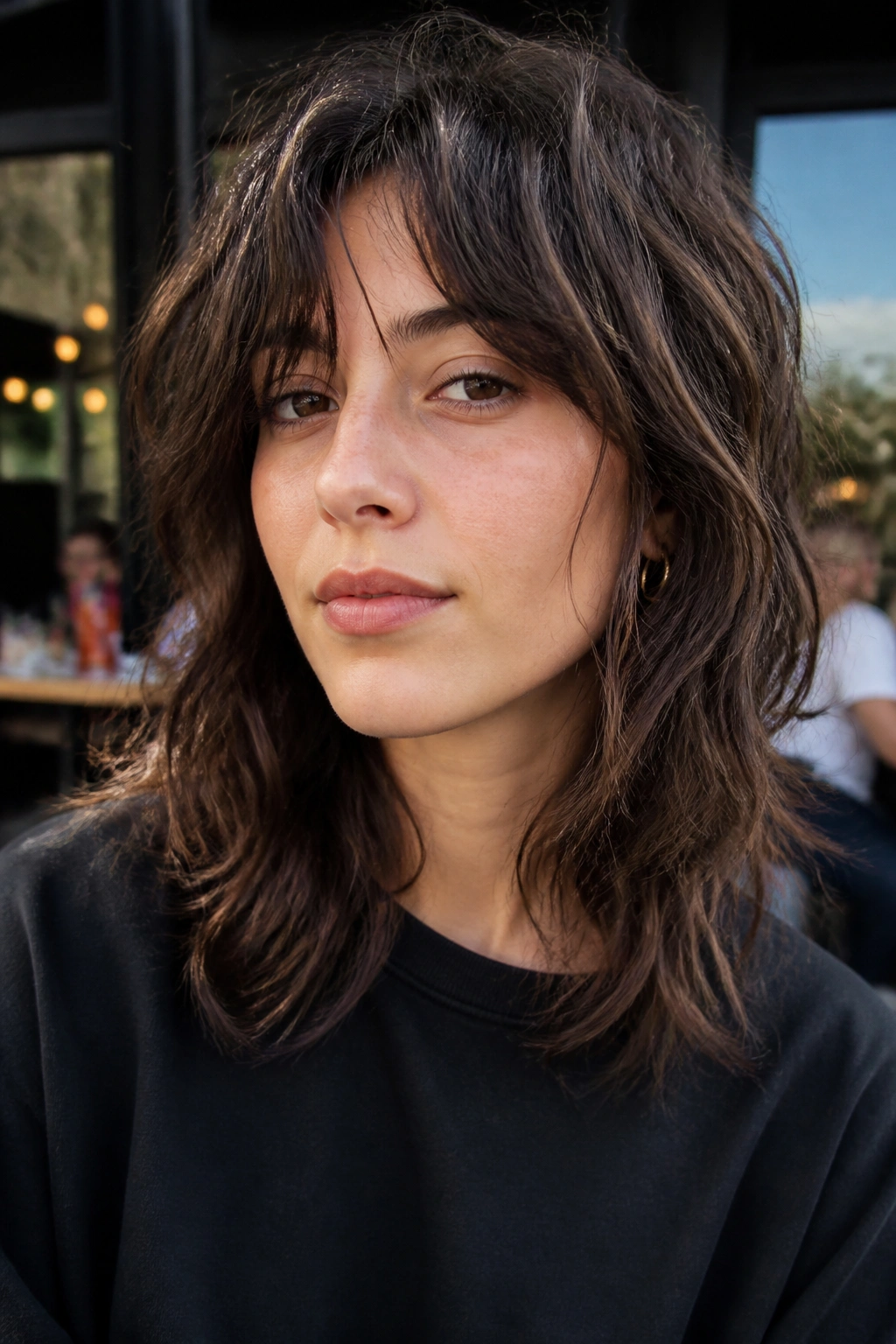 Close-up portrait of a real person with an air-dry wolf cut, natural texture and waves