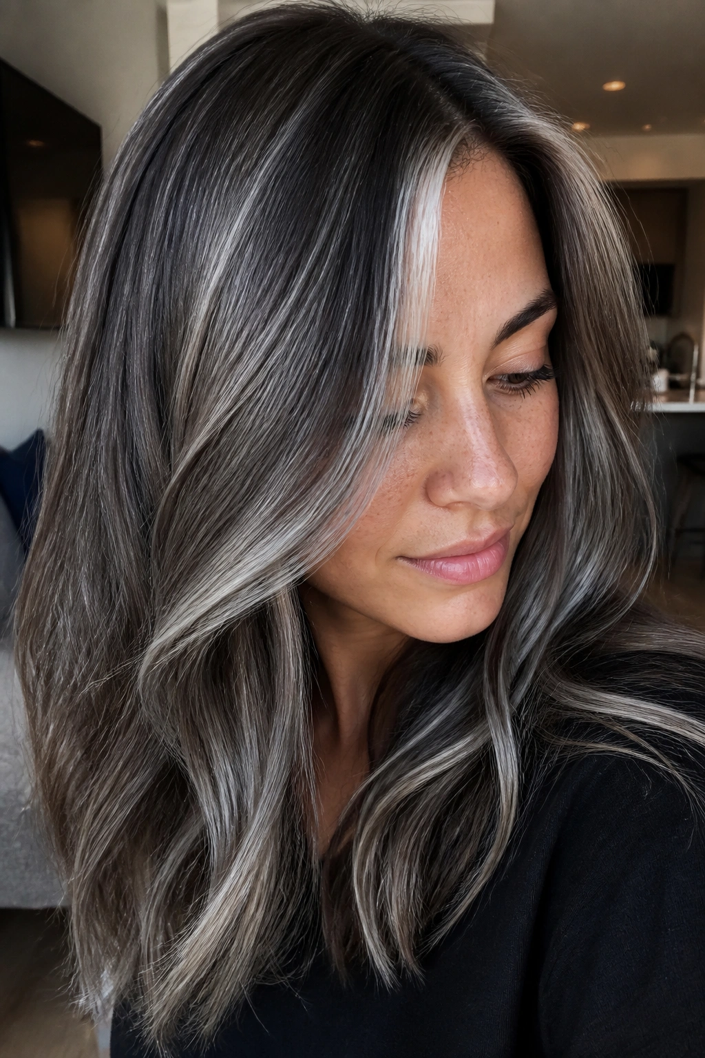 Portrait of a real woman with ash brown base and pewter threads in hair.