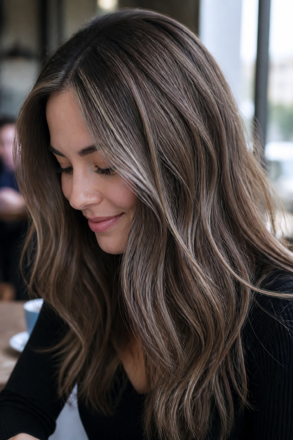 Close-up of a real woman with ash-grey babylights in brown hair