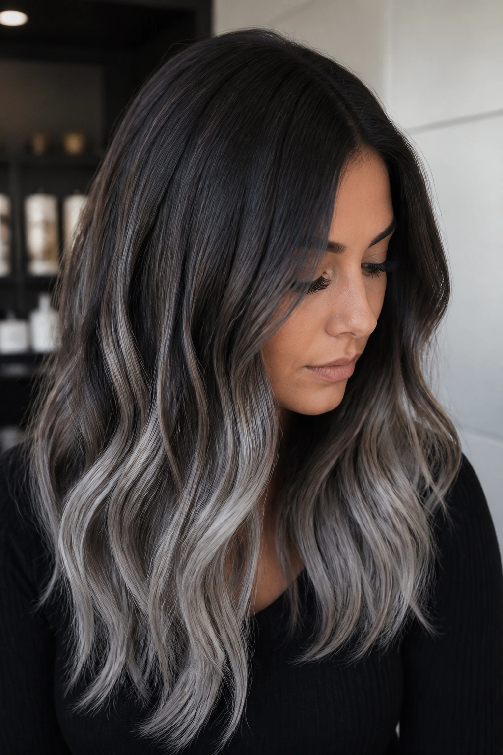 Close-up of dark chocolate hair with an ashy silver melt transition