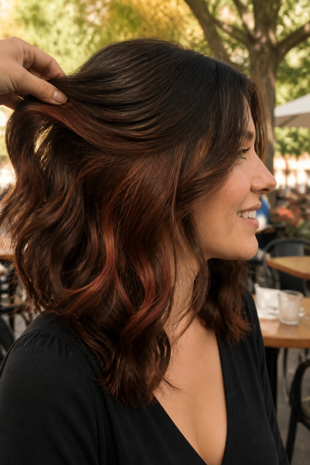 Shoulder-length brown hair with hidden auburn peekaboo pieces visible with movement