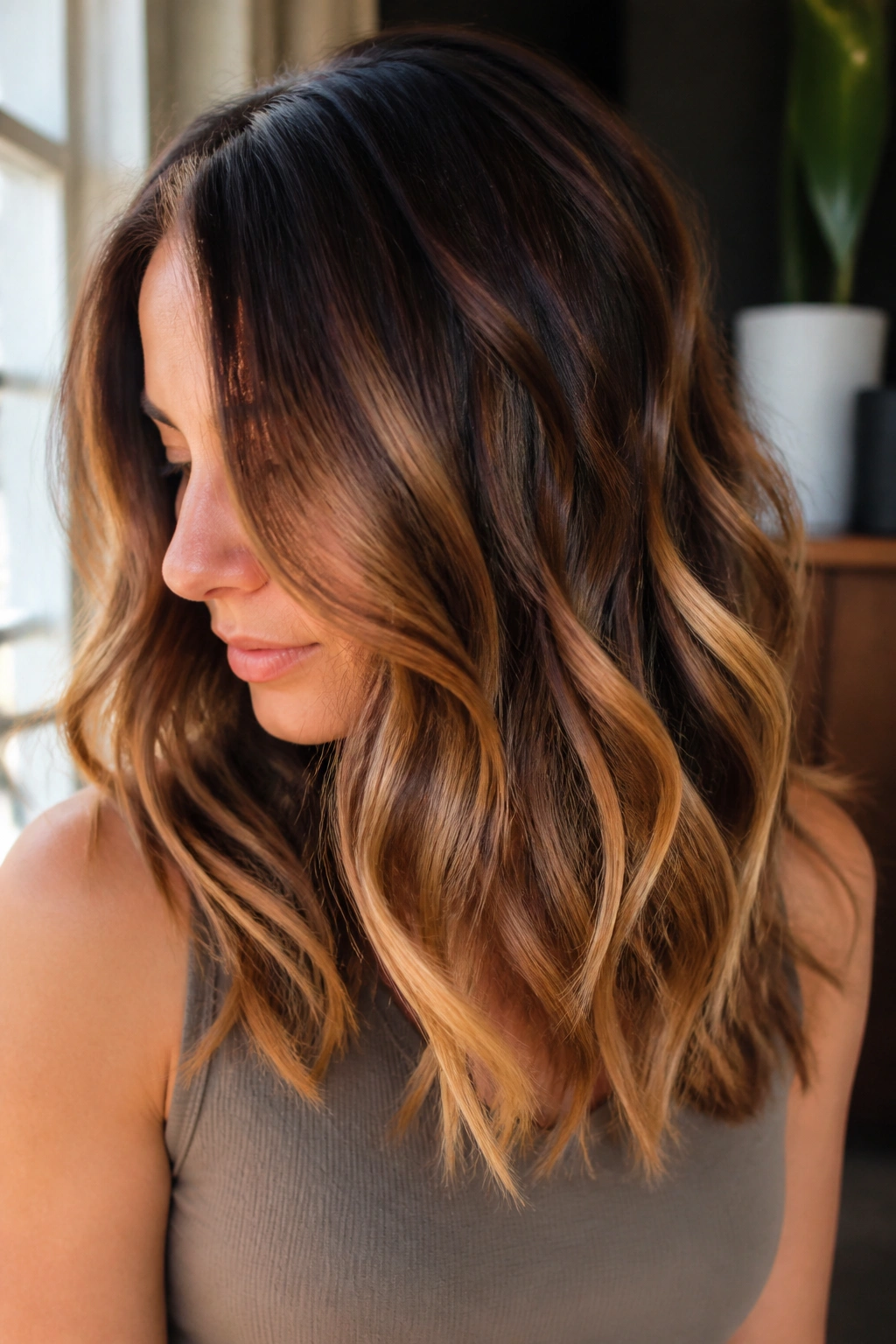 Close-up of brown hair with melted caramel balayage and chunky ends