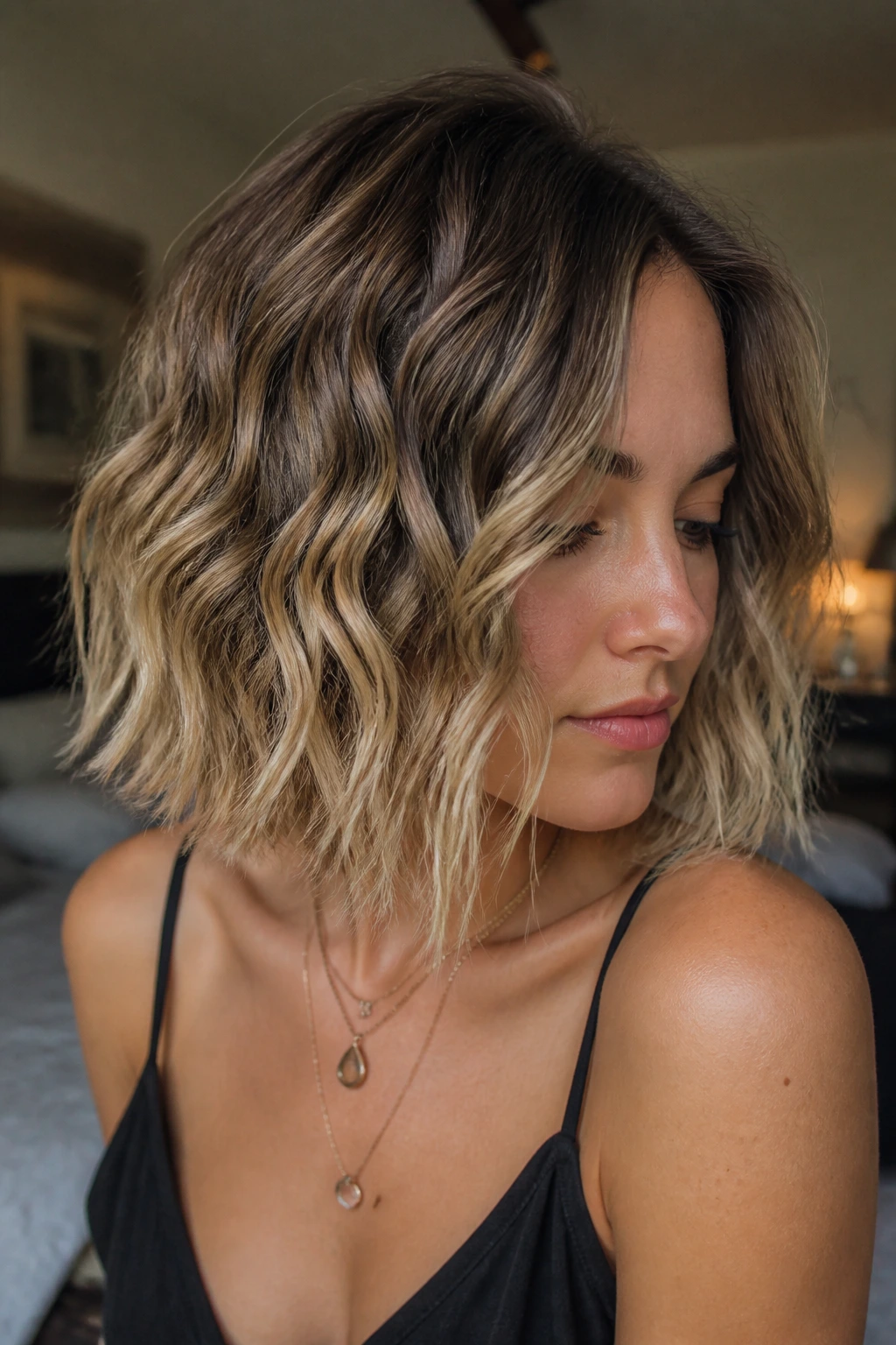 Close-up of Balayage Crinkle Cut Bob on a real woman showing warm caramel balayage in crinkles