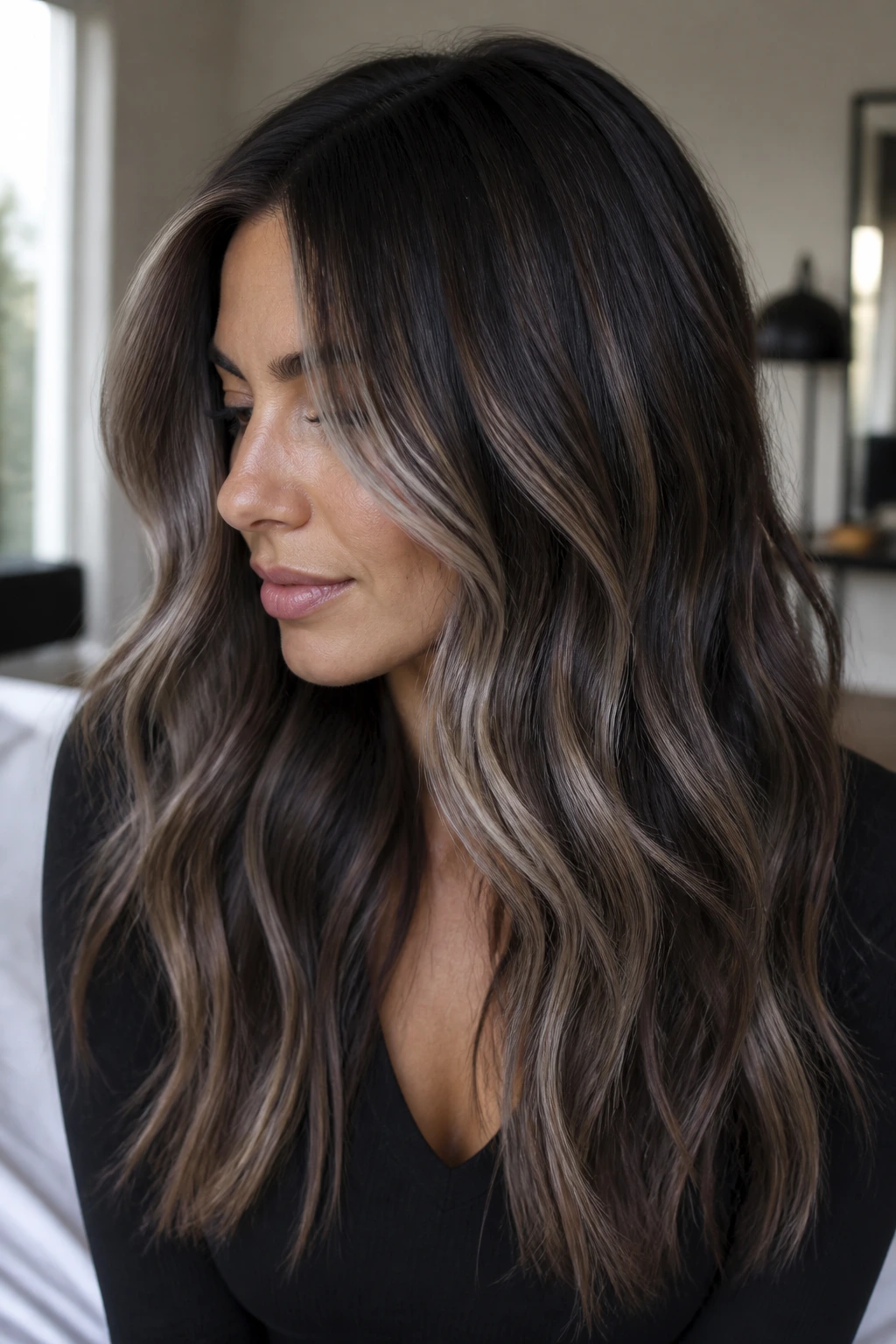 Portrait of a woman with cool-toned balayage on dark brown hair with ash highlights