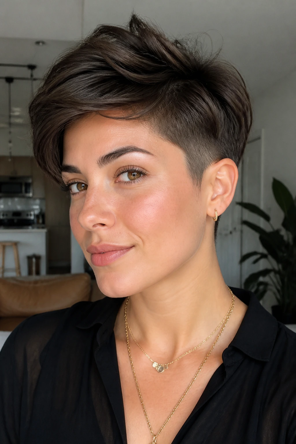 Portrait of a woman with bixie bob and short taper in a bright modern space