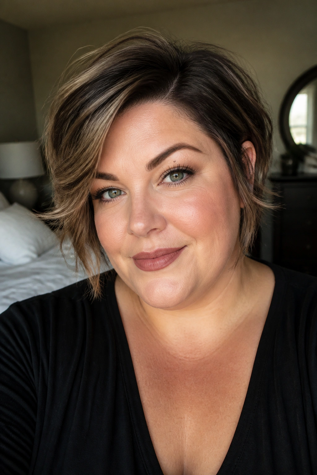 Close-up portrait of a real woman with a soft side-part bixie framing the cheekbones