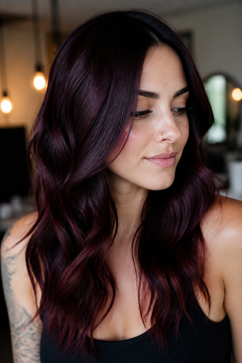 Close-up of a real woman with soft black cherry brunette hair showing ruby glow