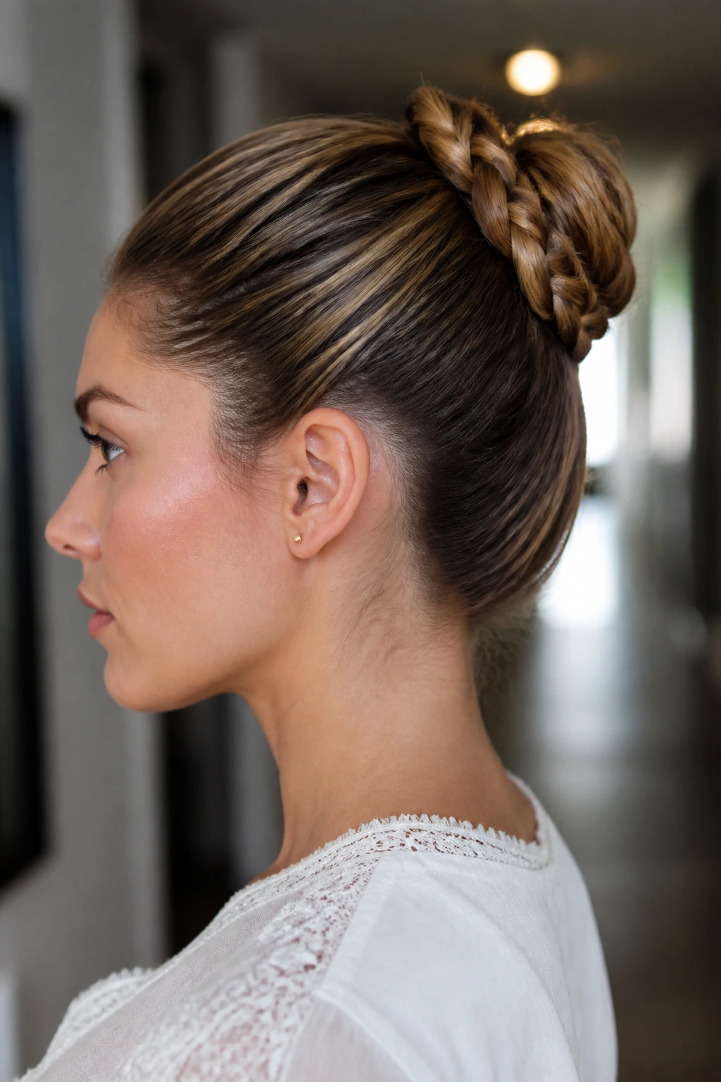 Rear-side view of braided ponytail wrapped into a bun
