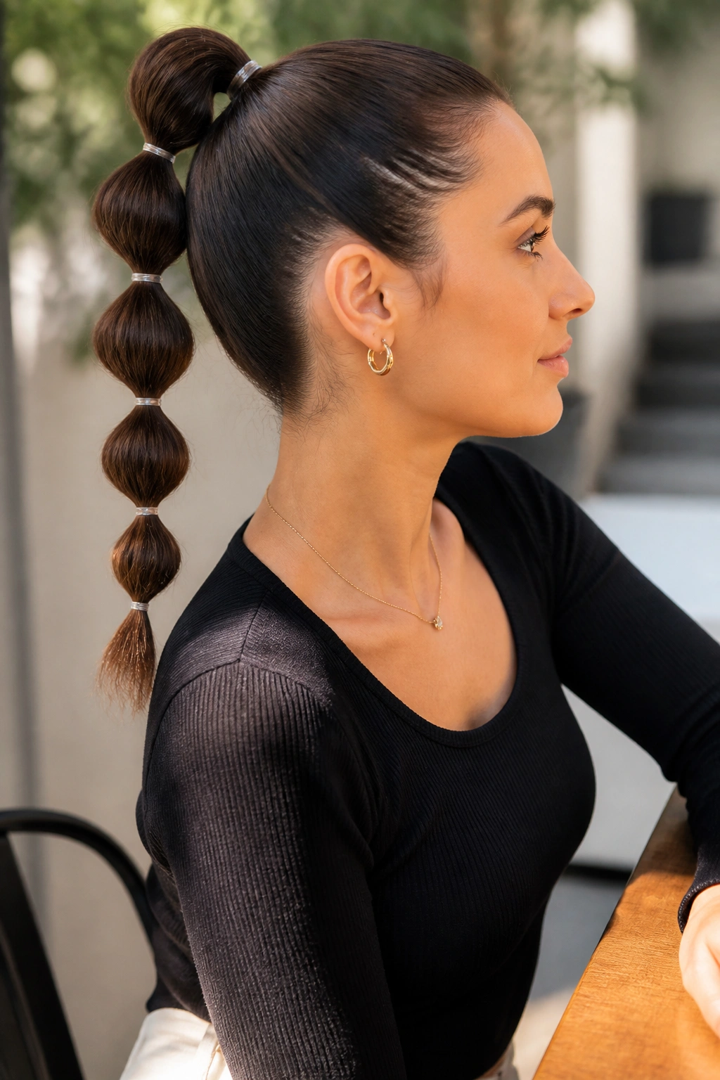 Side profile of a real woman with a bubble ponytail