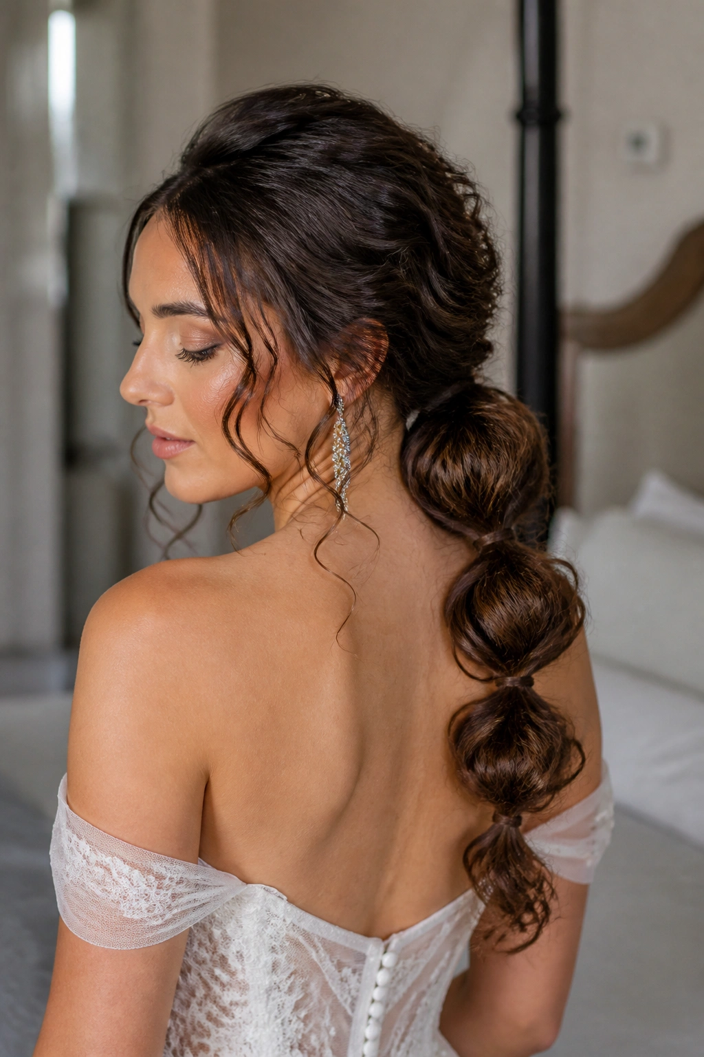Bride with a low bubble ponytail and defined curls
