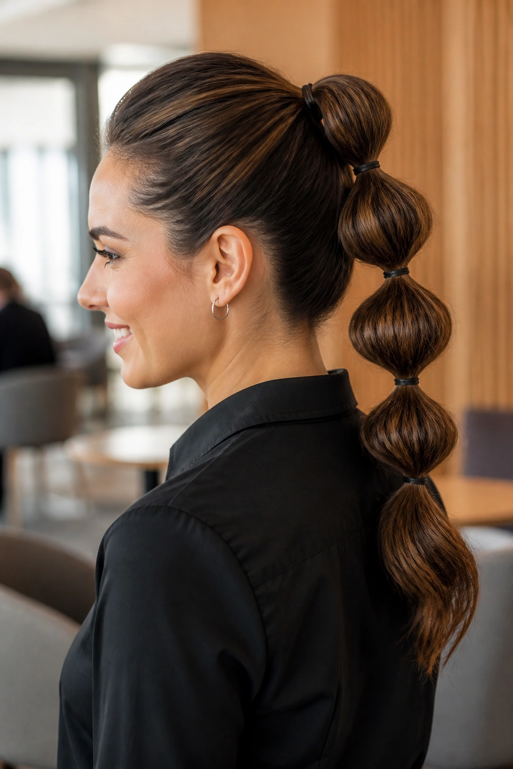Close-up of a real woman with a bubble ponytail in a modern office lounge