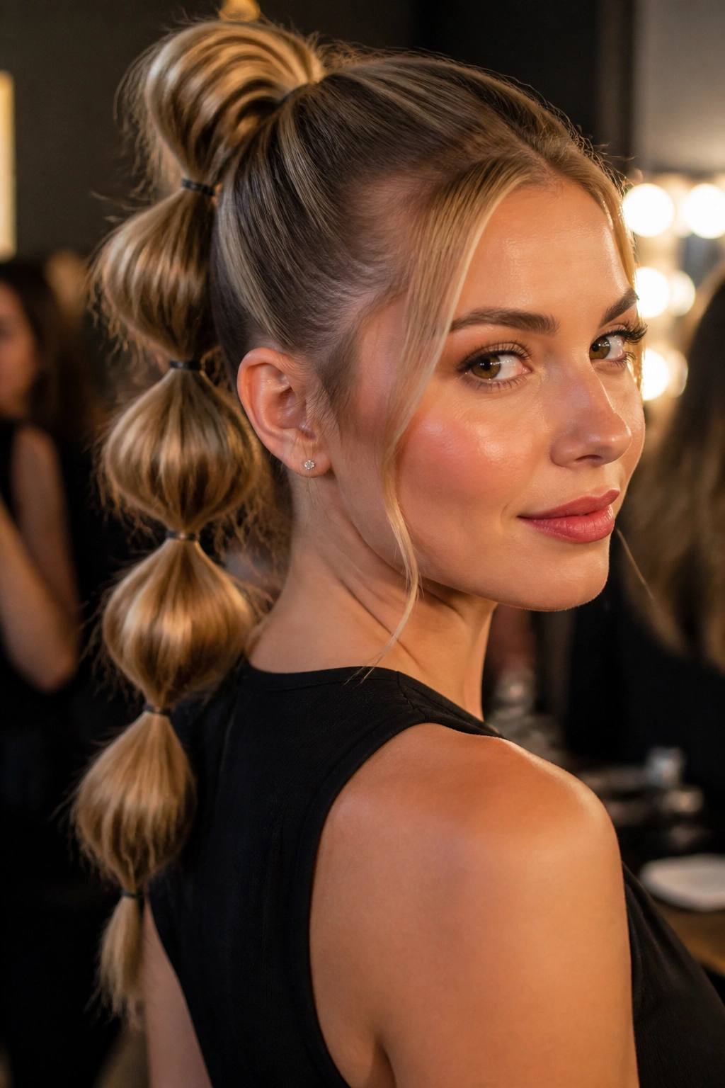 Close-up of a real woman with a bubble ponytail hairstyle.