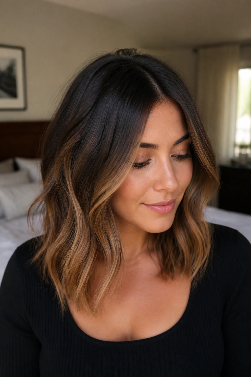 Close-up portrait of a real woman with caramel mocha ombre on shoulder-length hair, dark roots to caramel ends.
