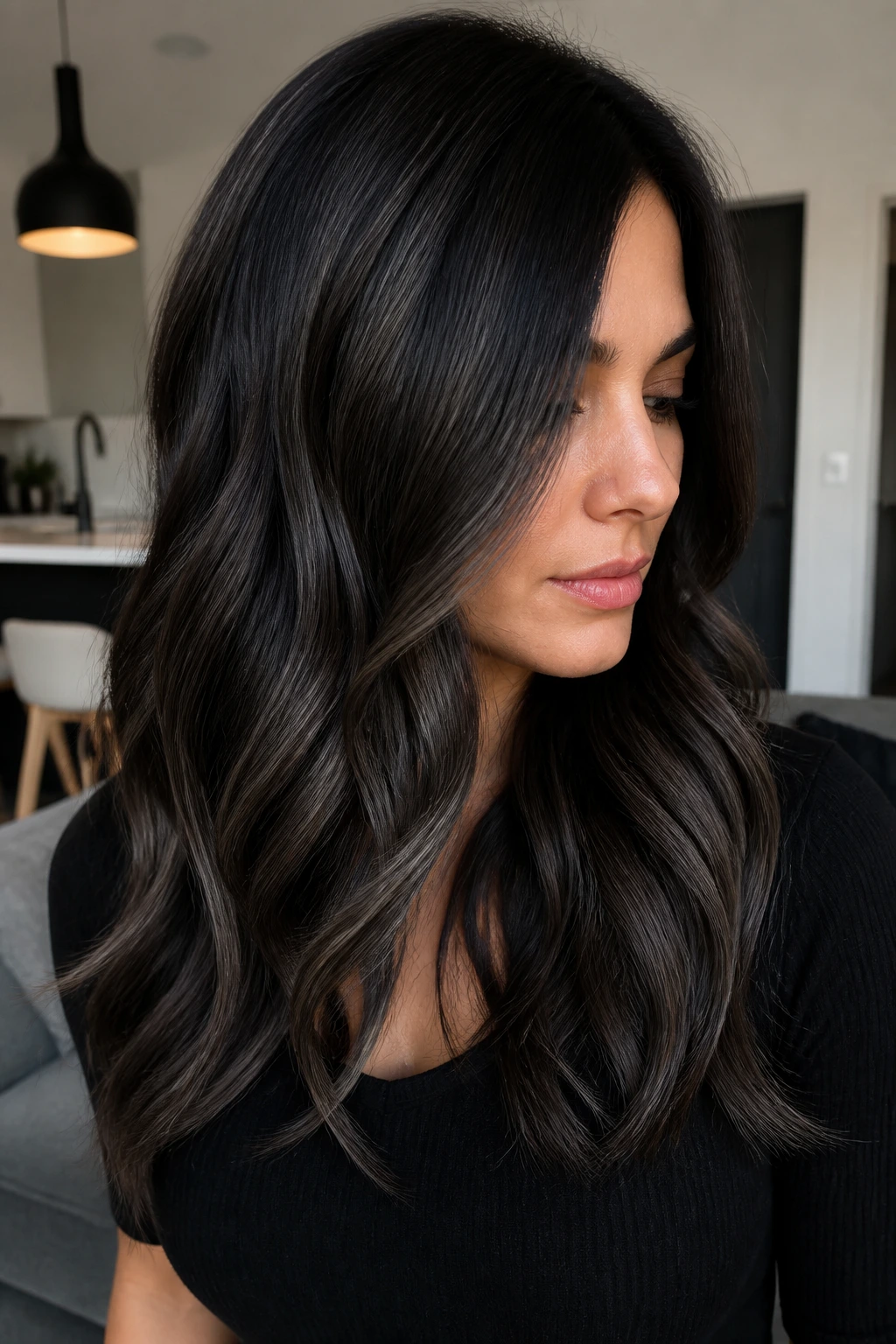 Close-up of a real woman with charcoal balayage on espresso hair