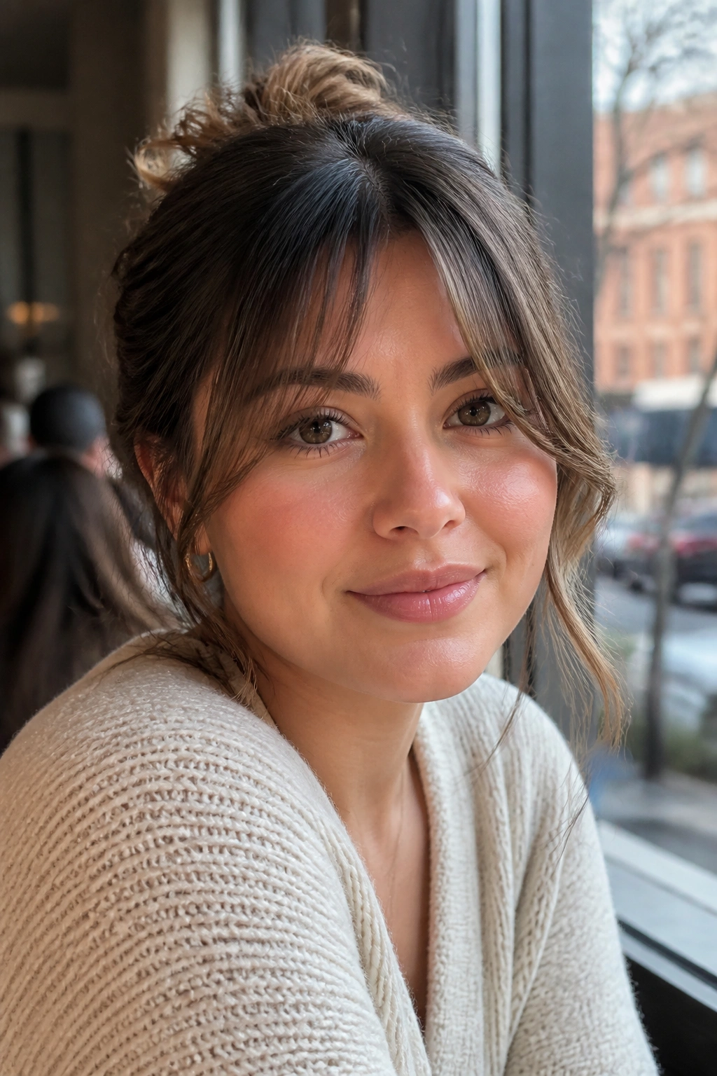 Close-up portrait of a real woman with cheekbone-skimming fringe at the sides
