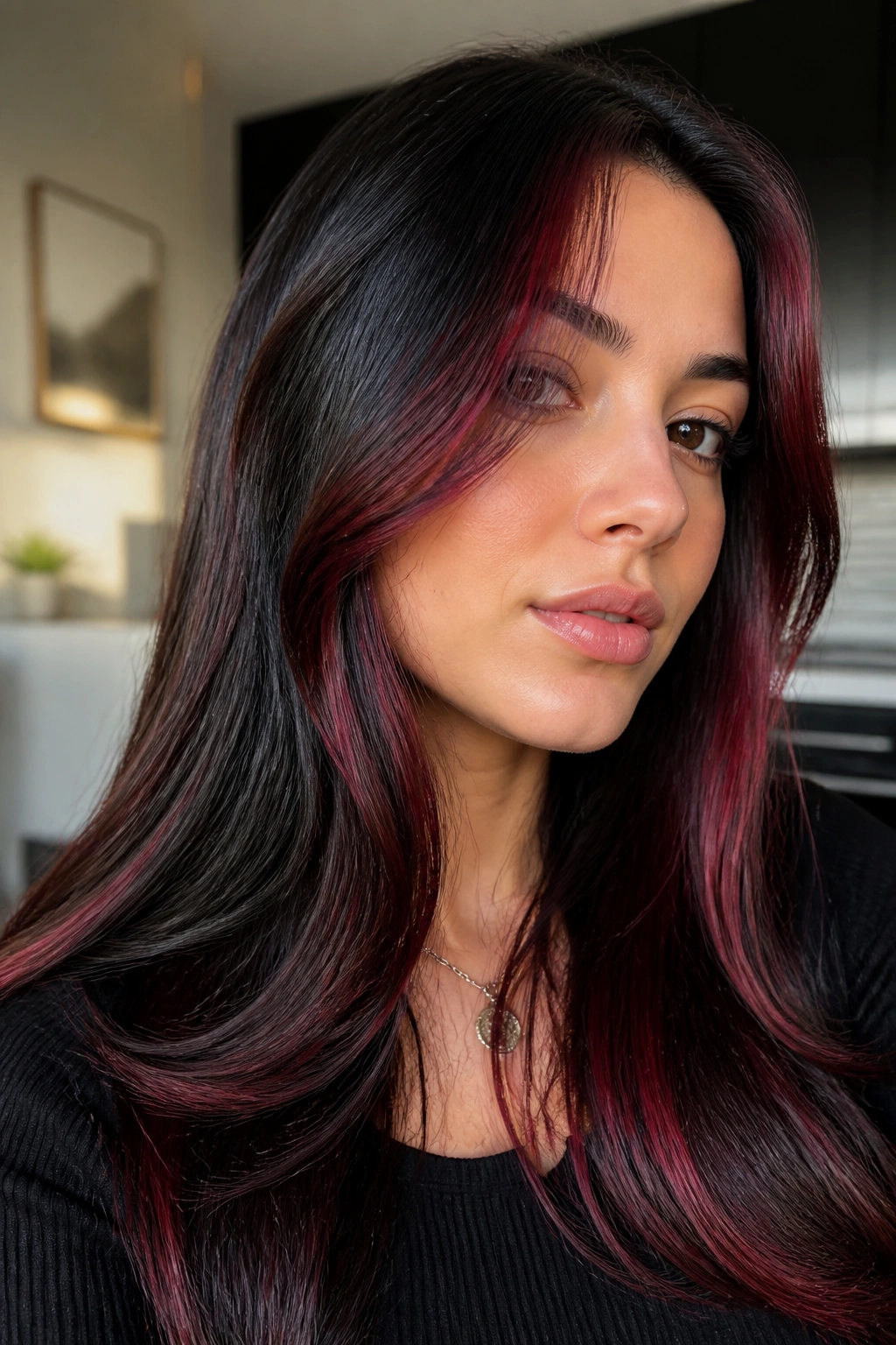 Close-up of a real woman with cherry cola red-violet streaks on black hair in natural light