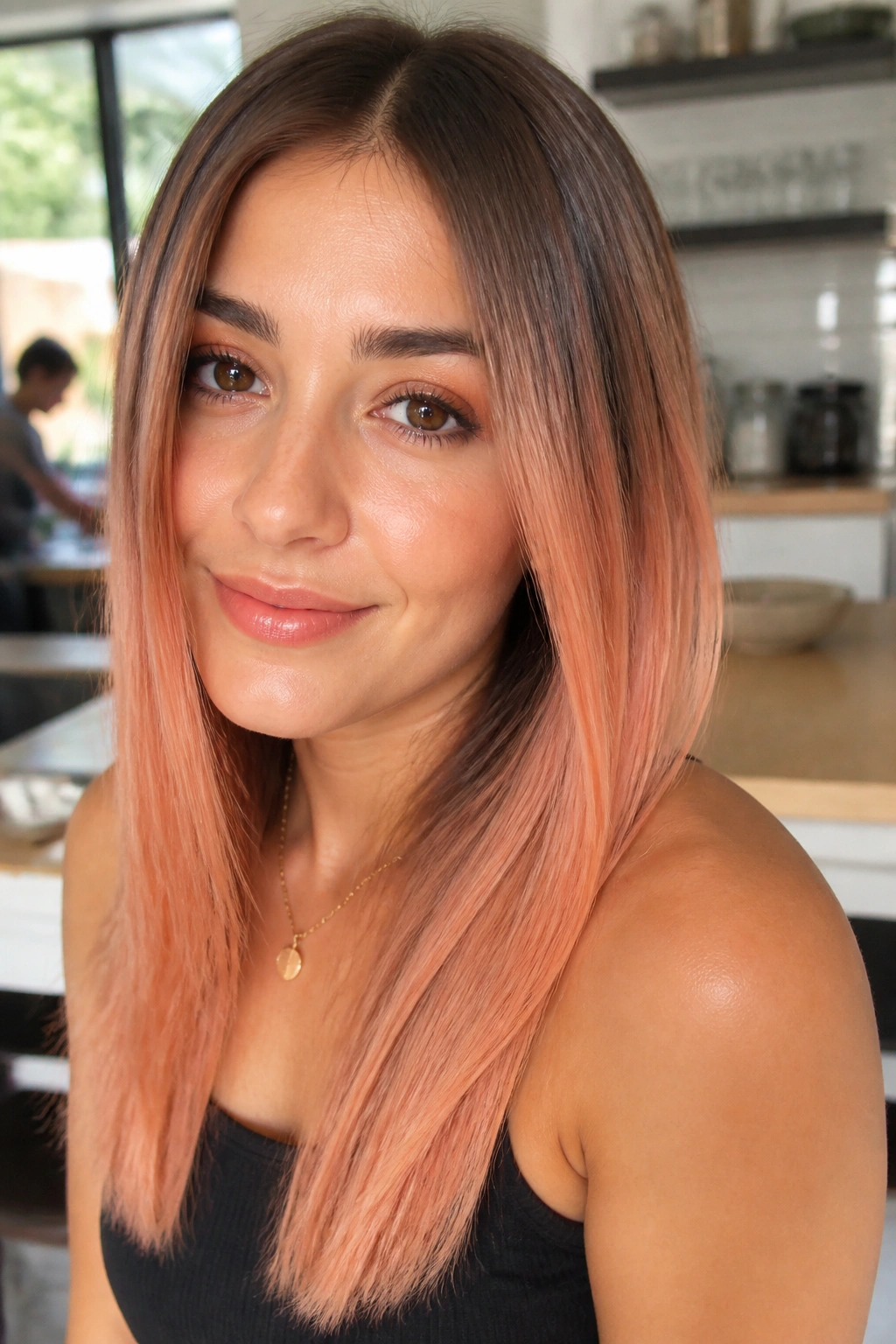 Close-up of a real woman with chestnut to peach melt on straight hair in natural daylight
