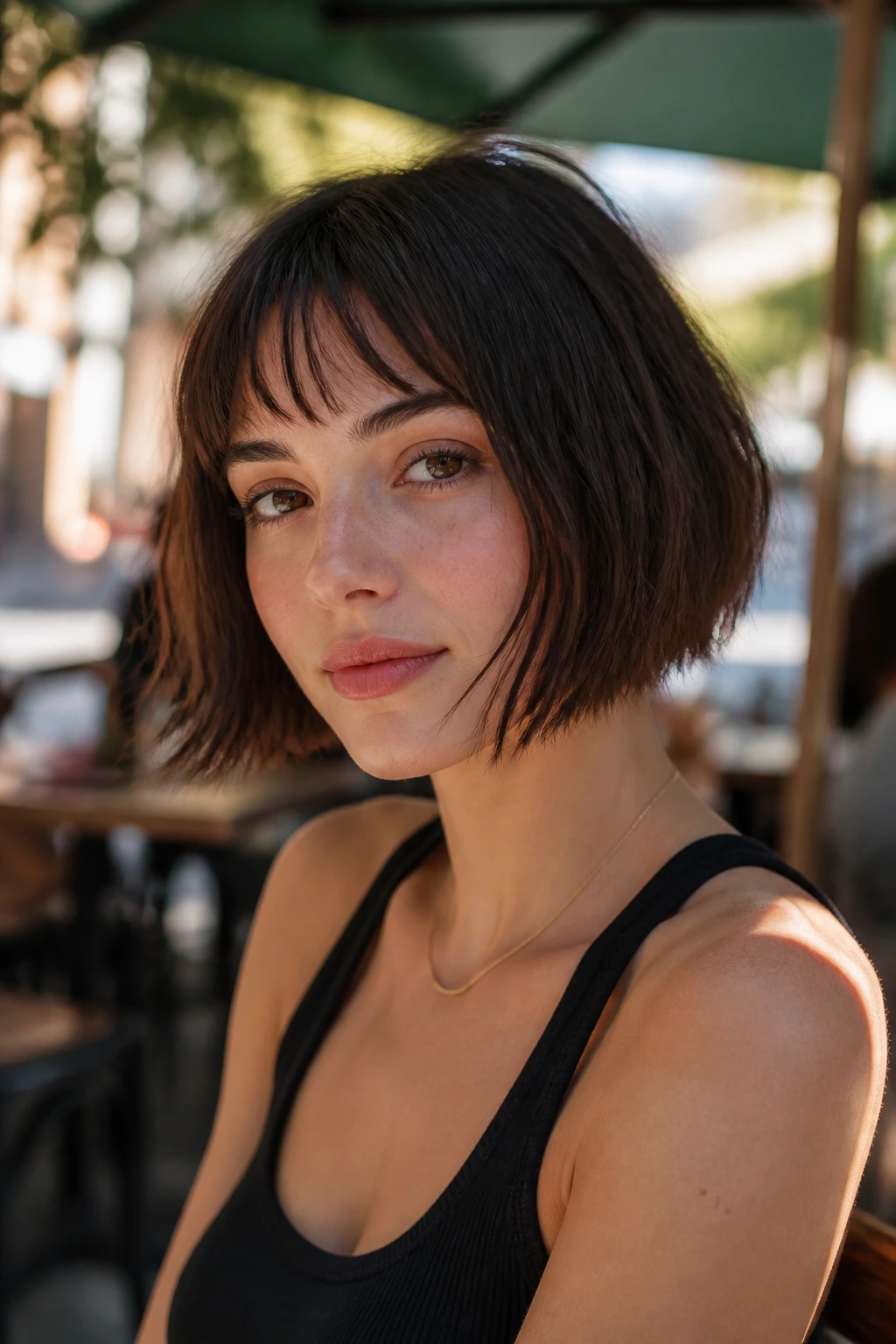 Close-up of a real person with a chin-length box bob with choppy ends