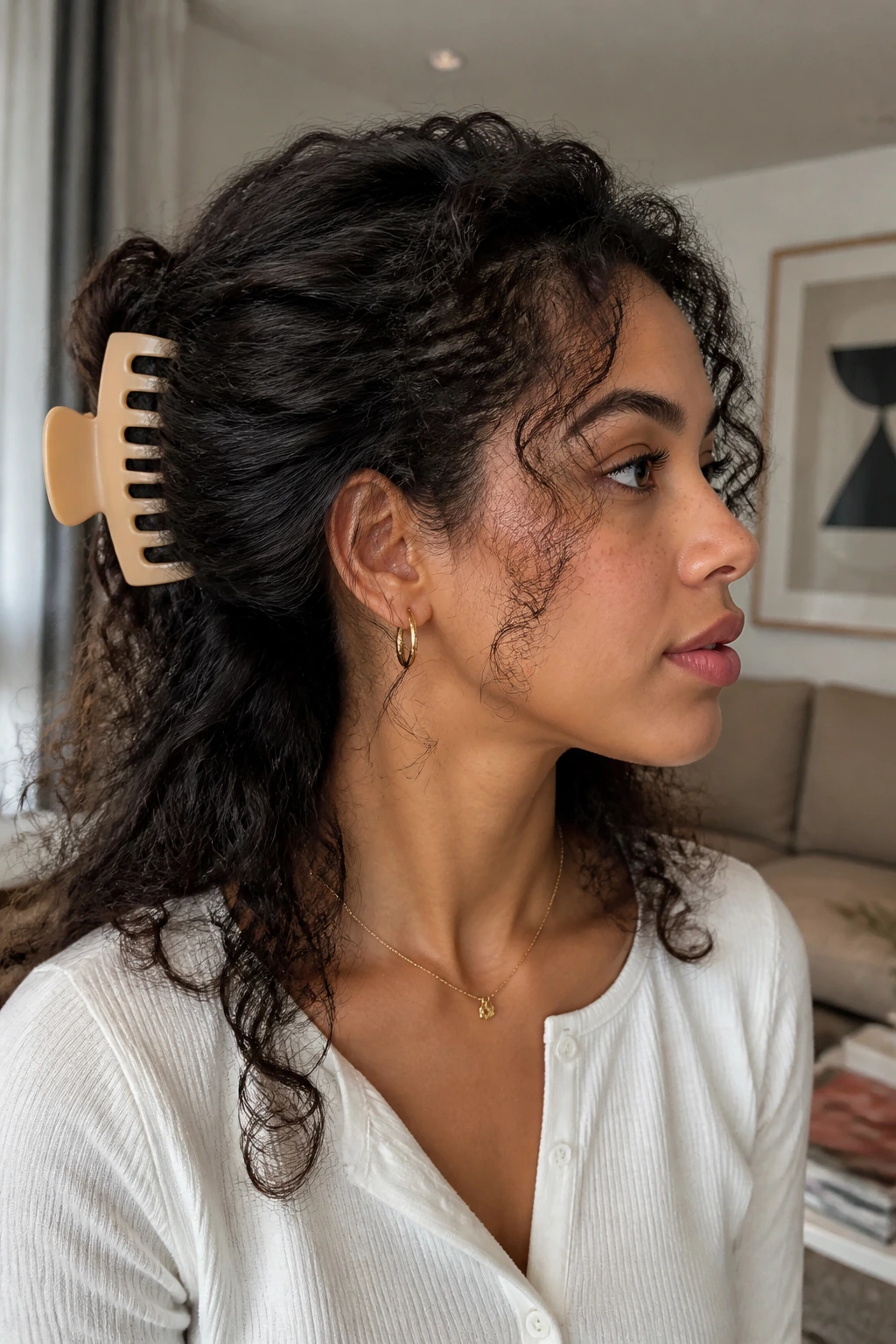 Claw clip sweep hairstyle with loose curls on a real person