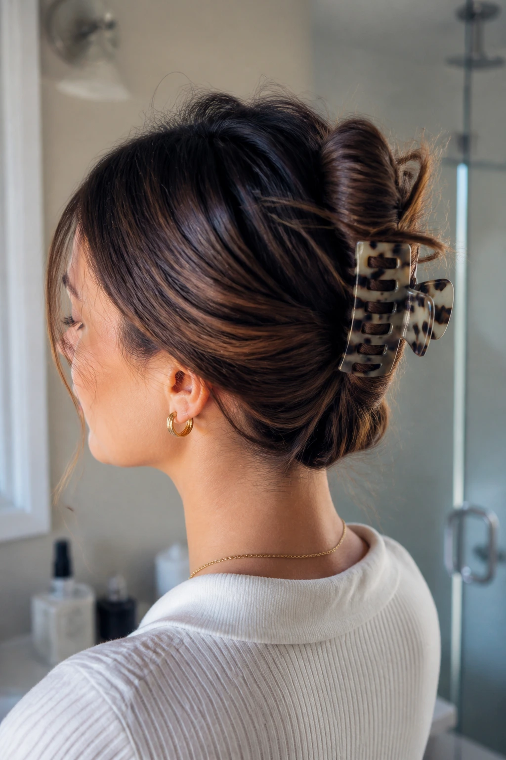 Close-up portrait of a real woman with a claw clip French twist hairstyle
