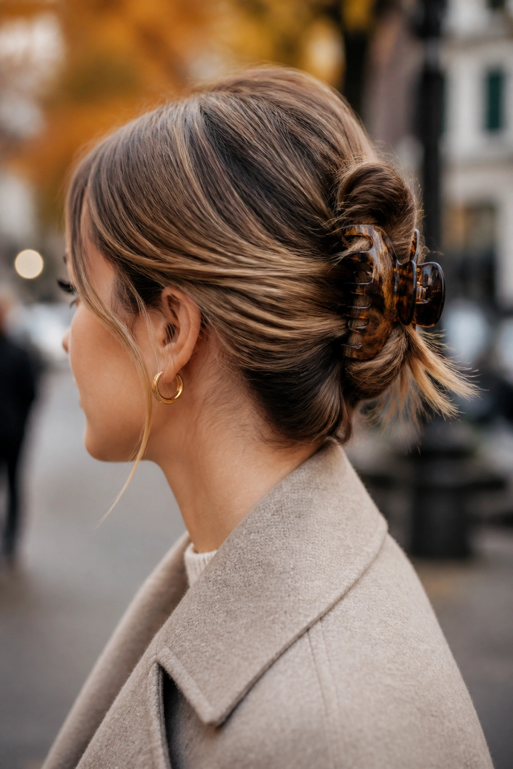 Profile view of claw clip twist secured at the crown on medium-long hair