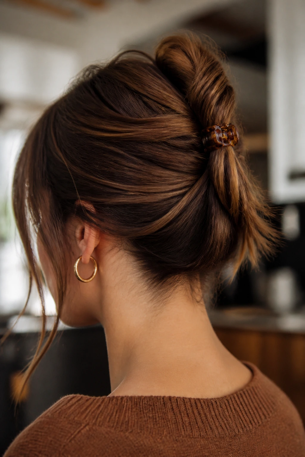 Three-quarter profile of real person with hair twisted and clipped with a small claw clip