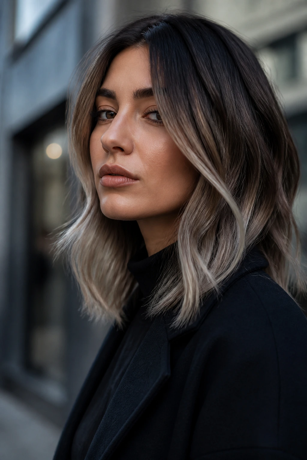 Portrait of a real person with cool brunette balayage and silver beige ends.