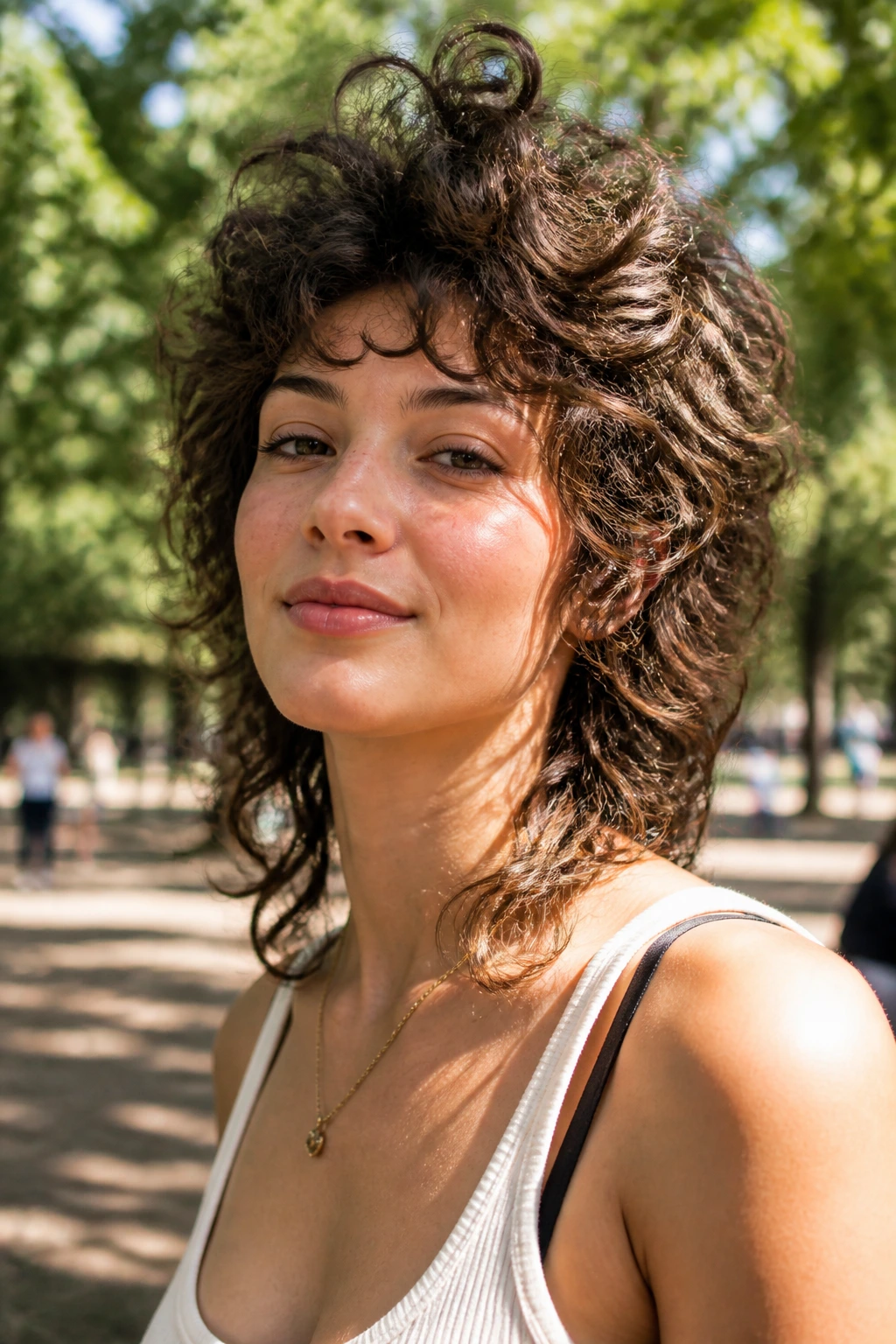 Portrait of a real person with a crown-height wolf cut outdoors in natural light.