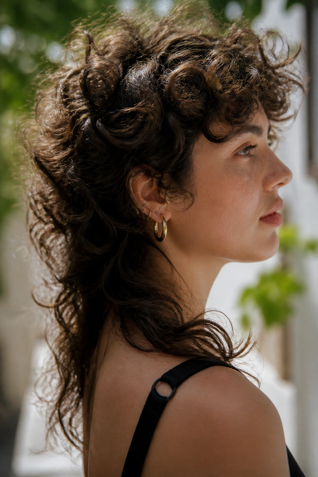 Real person with curly halo mullet hairstyle in natural outdoor lighting