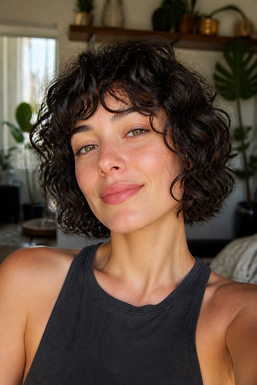 Close-up of a real woman with curly shag bob and jaw-grazing layers