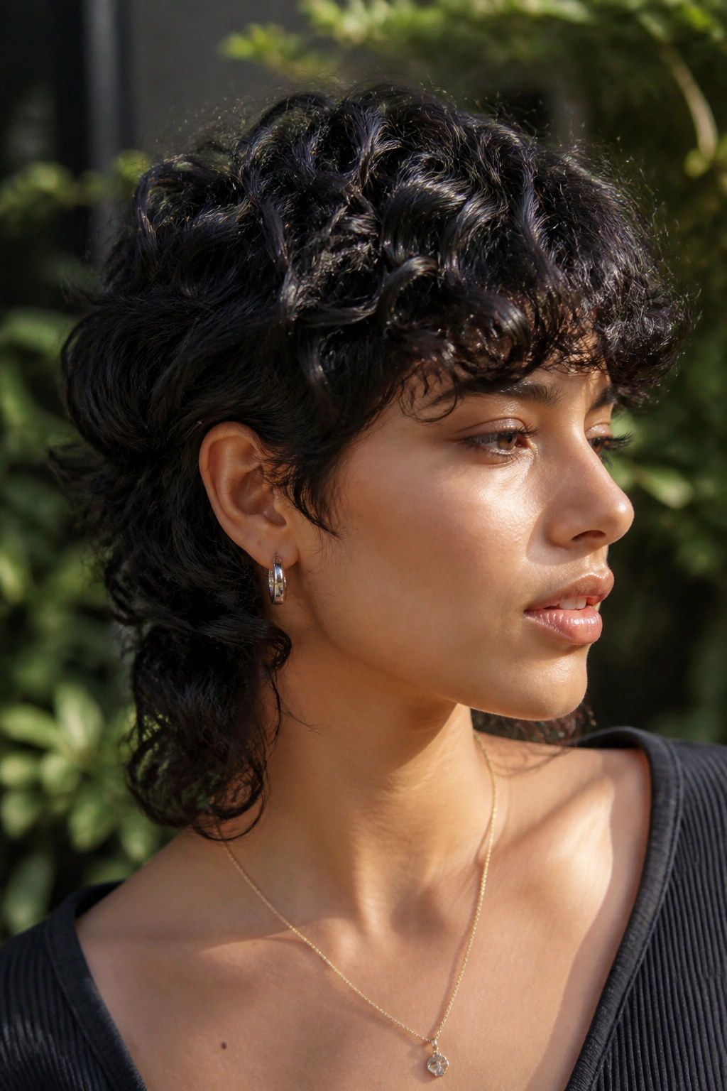 Real person with curly black wolf cut and defined crown layers