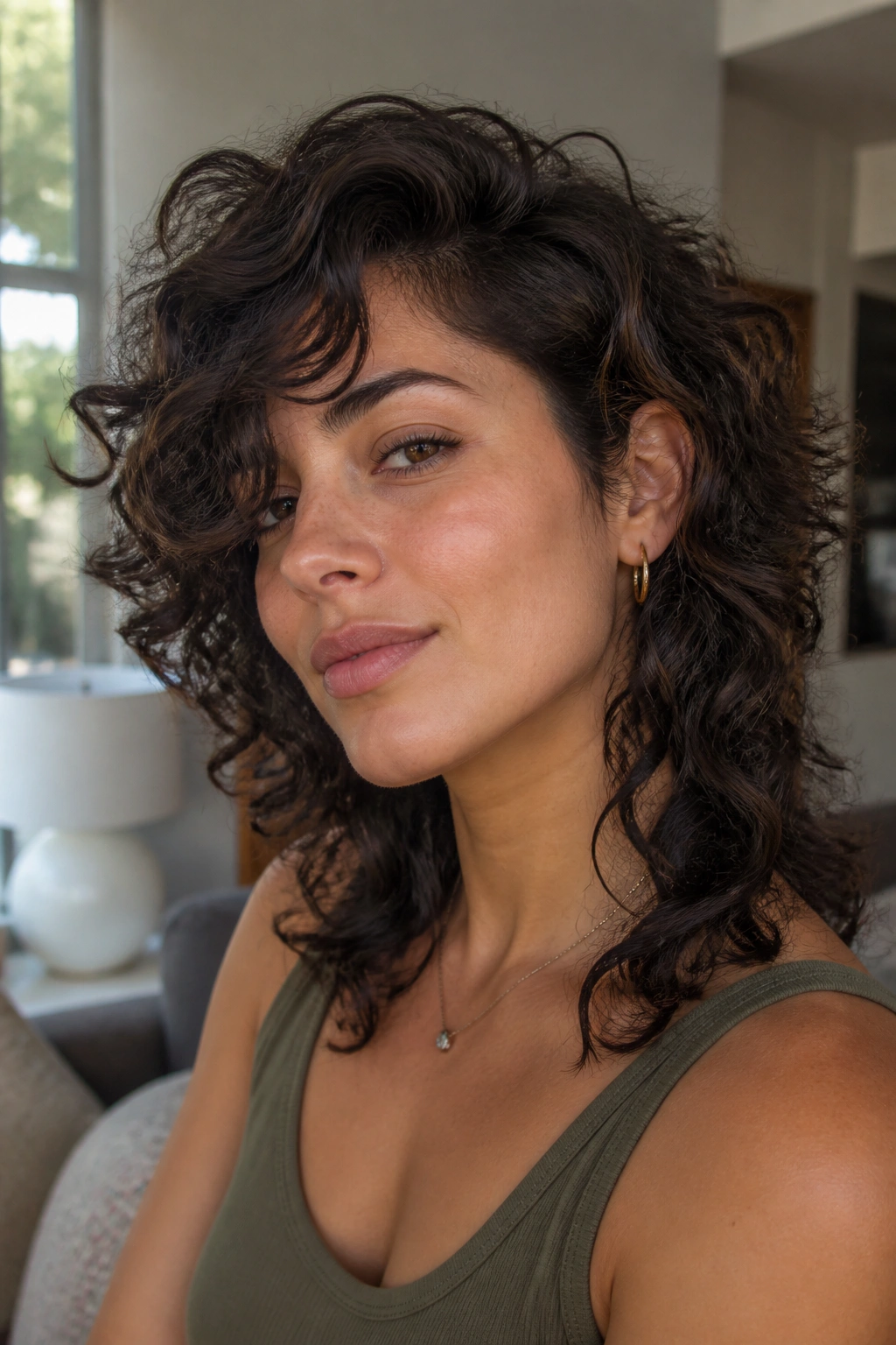 Close-up portrait of a real woman with a curly wolf cut and deep side part