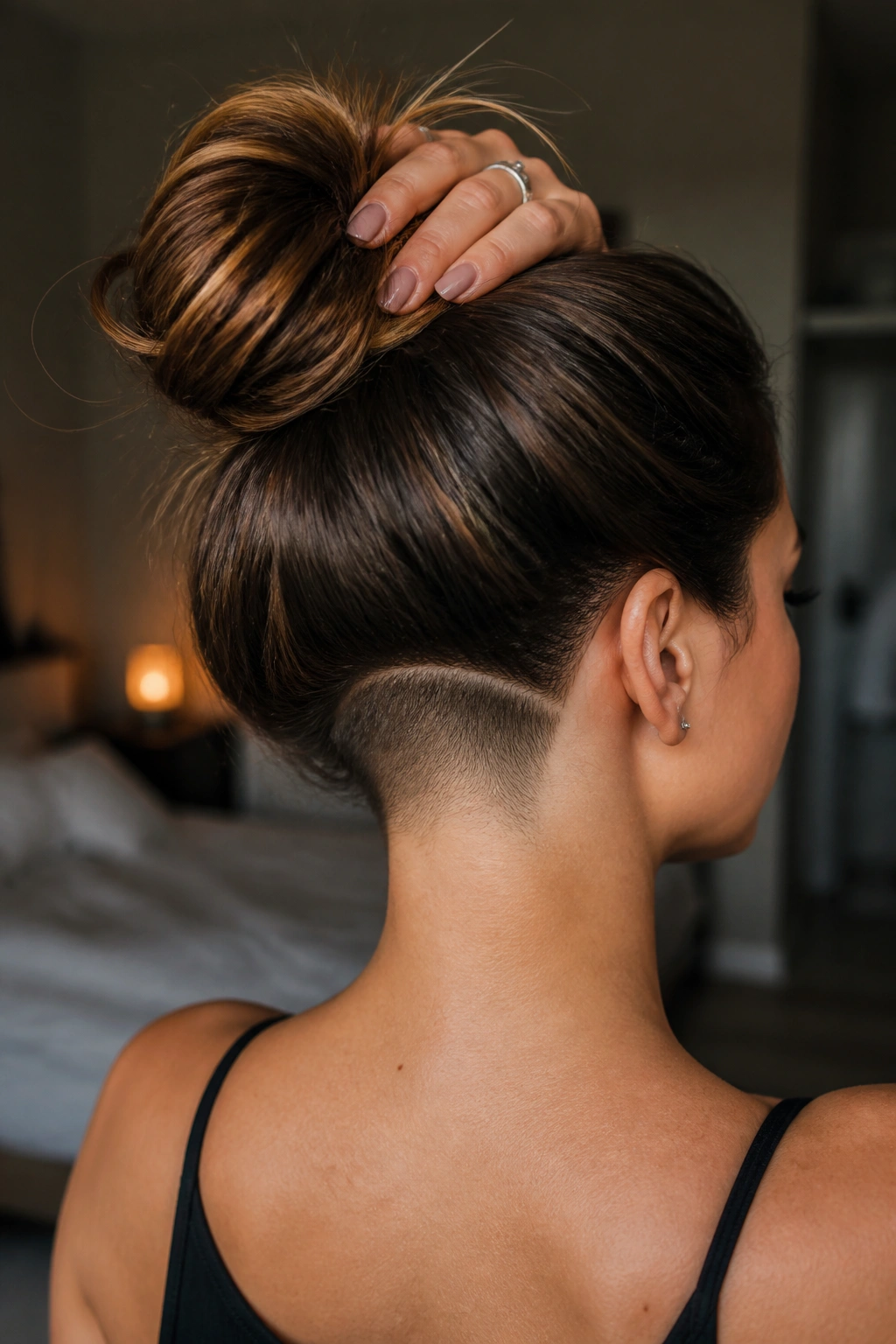 Back view of woman with curved nape undercut following hairline