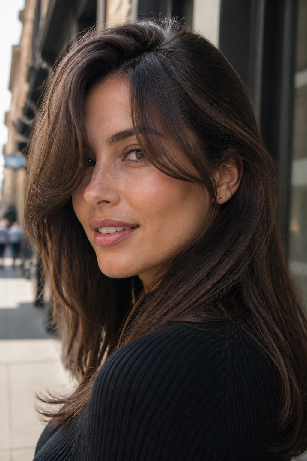 Close-up profile of a person with deep side part curtain bangs in urban daylight