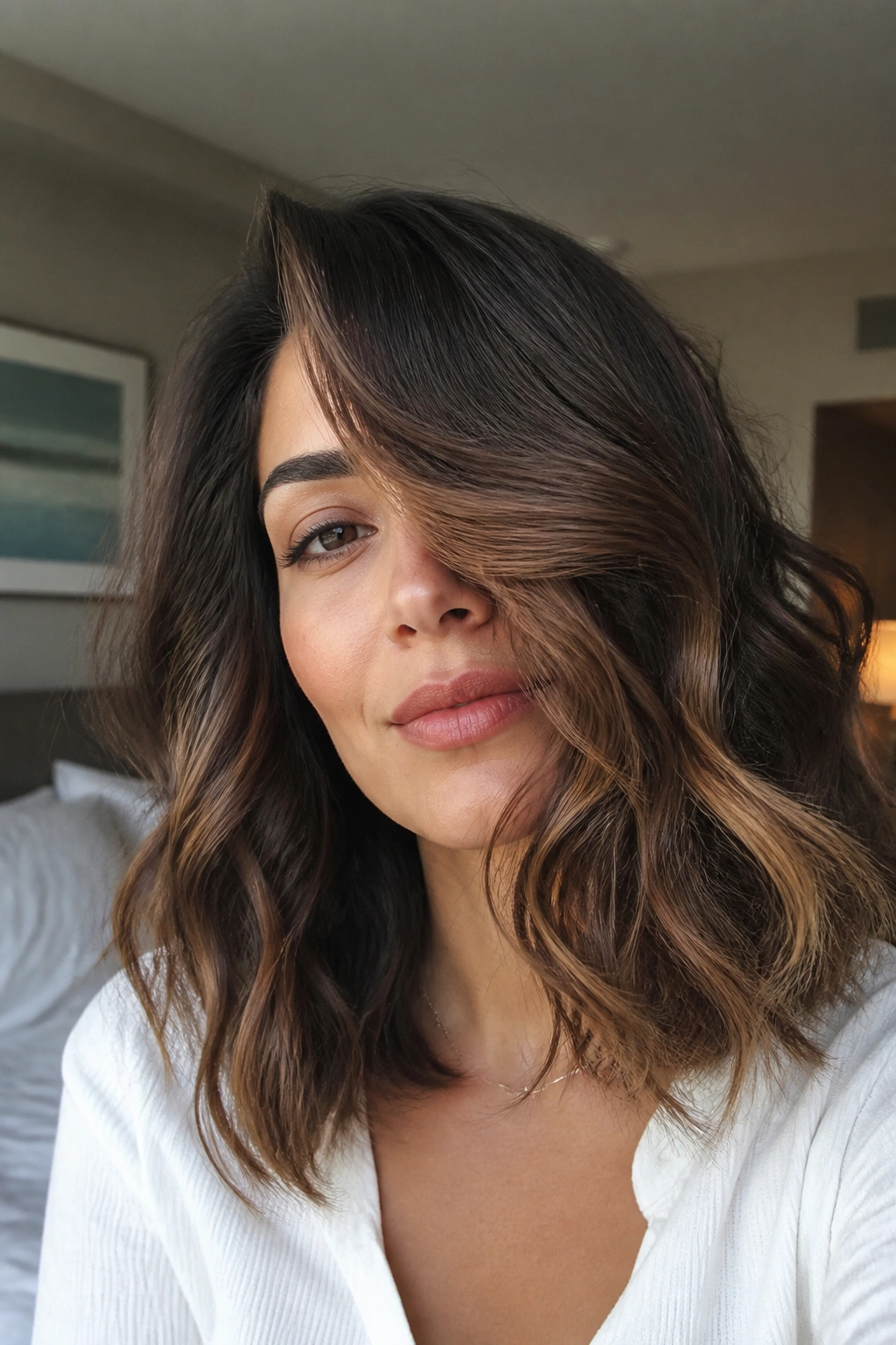 Portrait of deep side-part waves sliding over one eye