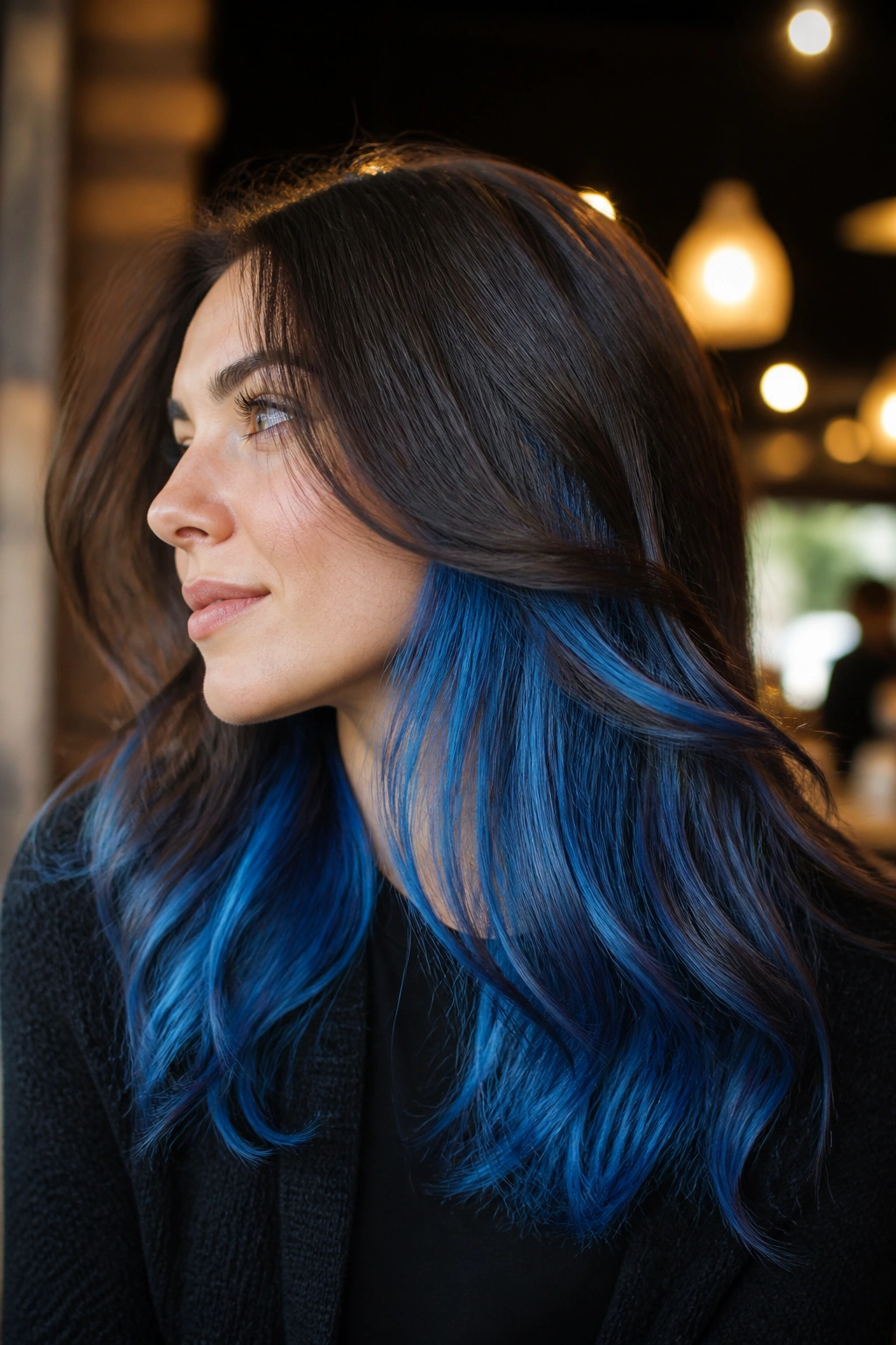 Close-up of denim blue peekaboo underlayer visible in hair