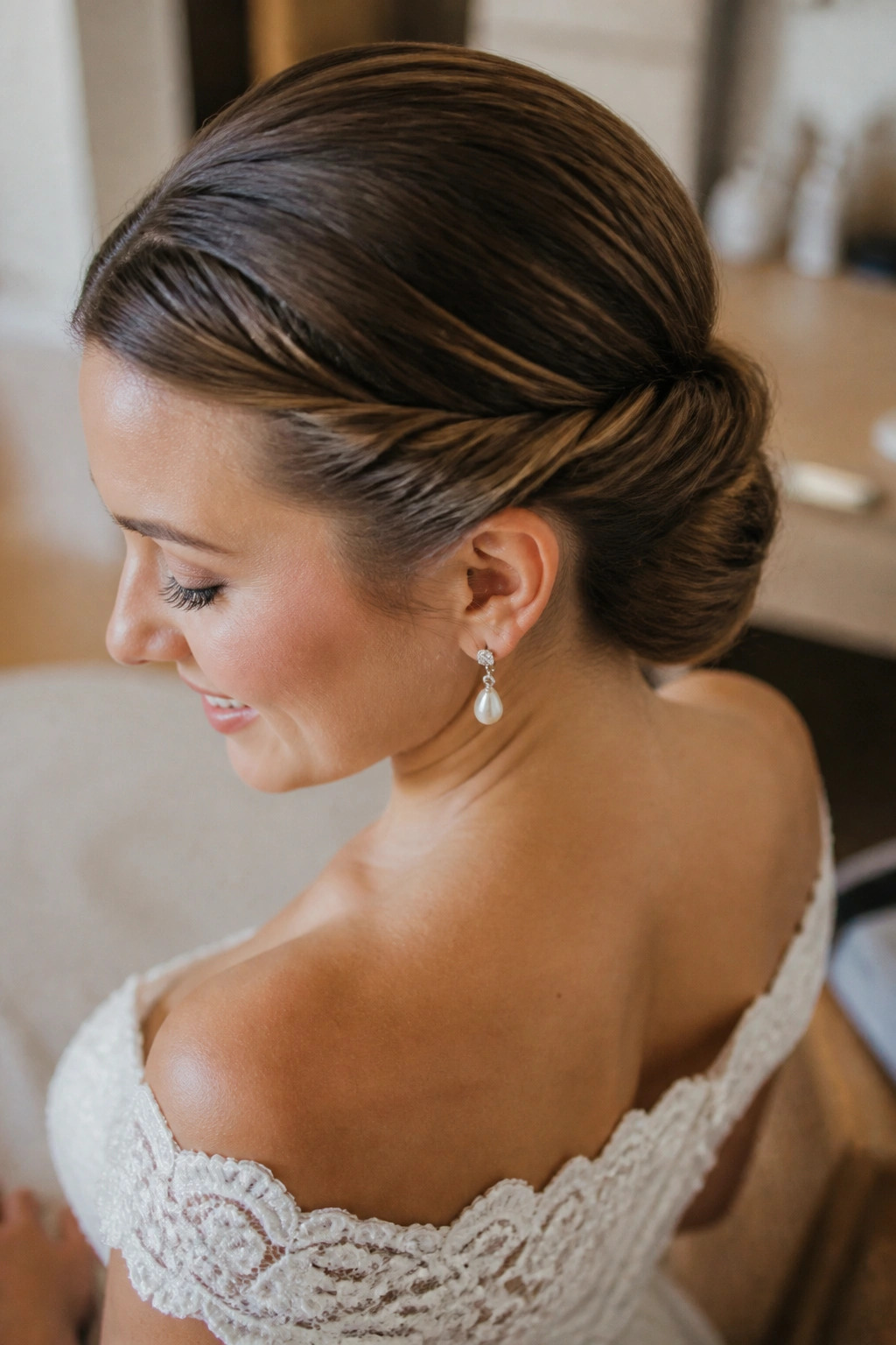 Close-up of a real bride with a double-twist low updo and smooth back.