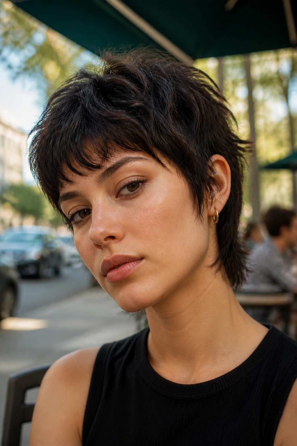 Real person with edgy mini wolf cut showing lived-in texture in outdoor cafe setting.
