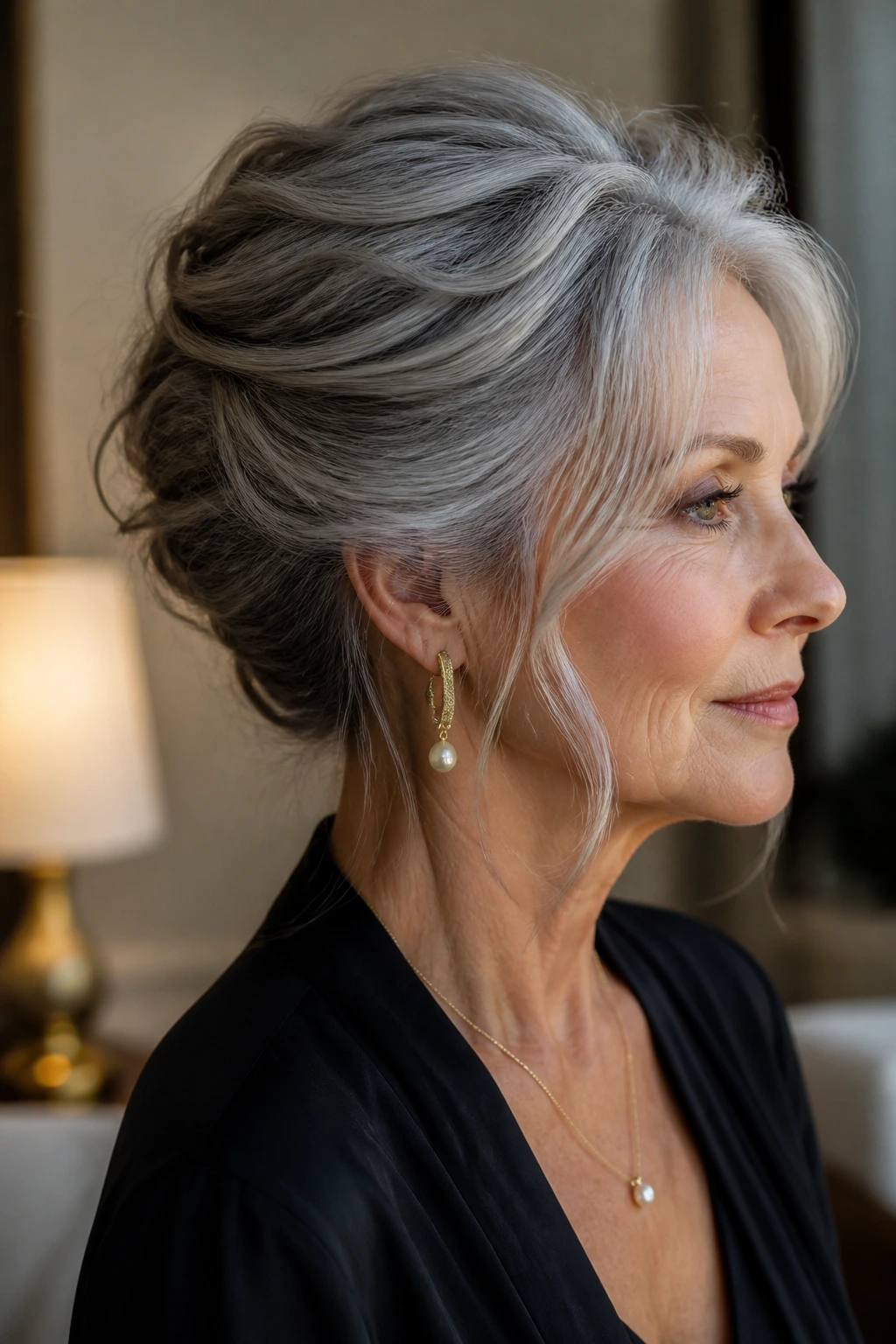 Portrait of a woman with an elegant French twist and soft pieces in gray hair