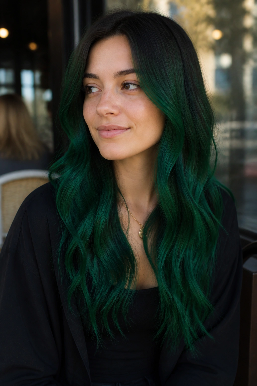 Medium close-up of person with emerald green hair along the lengths