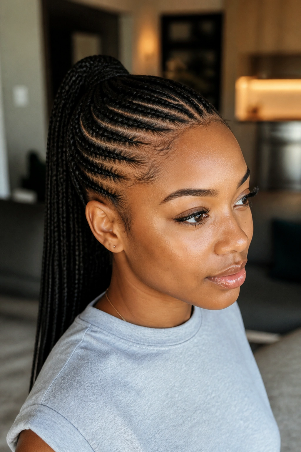 Real woman with feed-in cornrow ponytails forming a smooth ponytail.