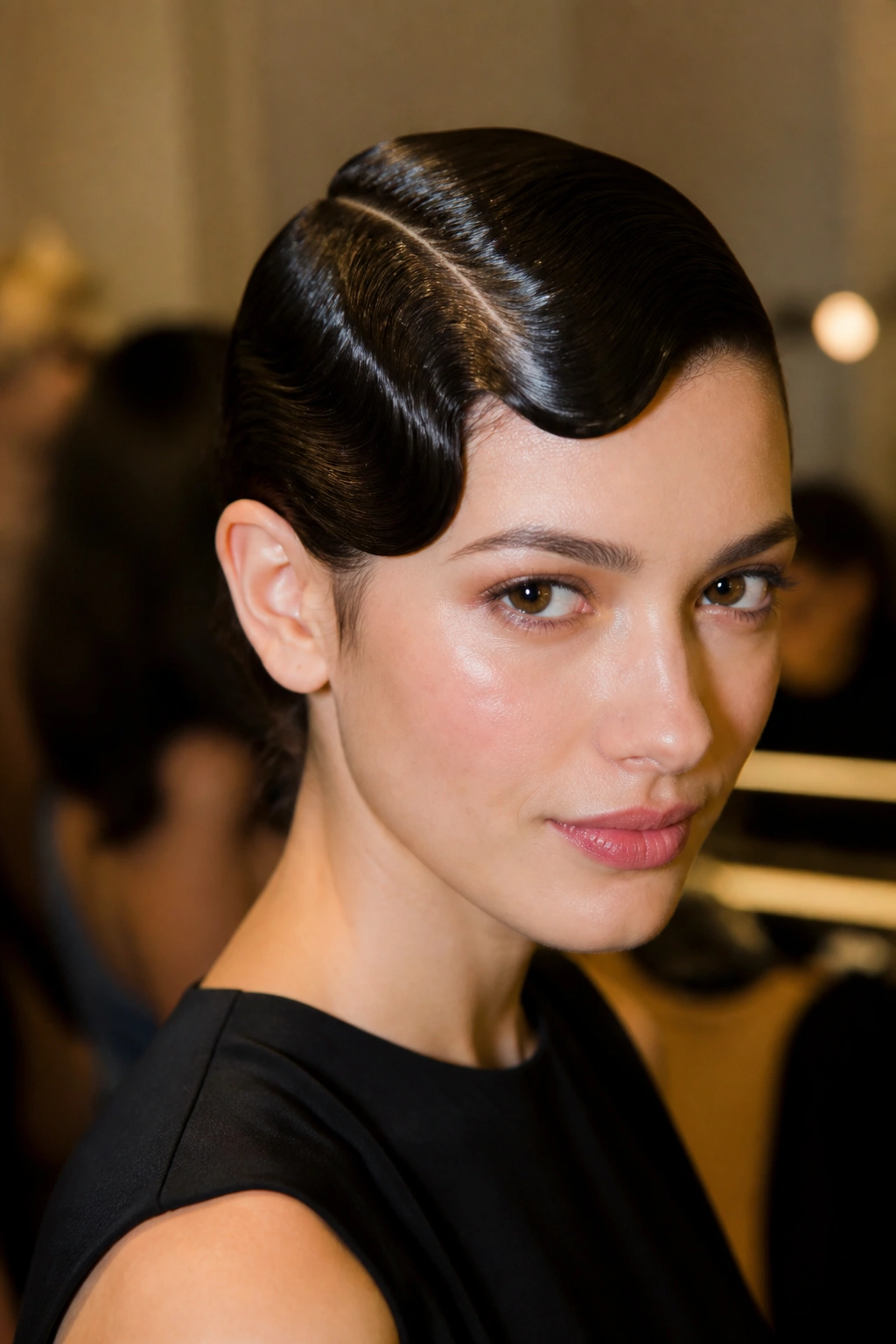 Close-up of a woman with sculpted short hair and finger waves