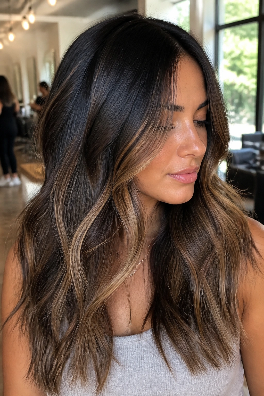 Close-up of a real woman with foilyage on dark hair for a soft lifted look