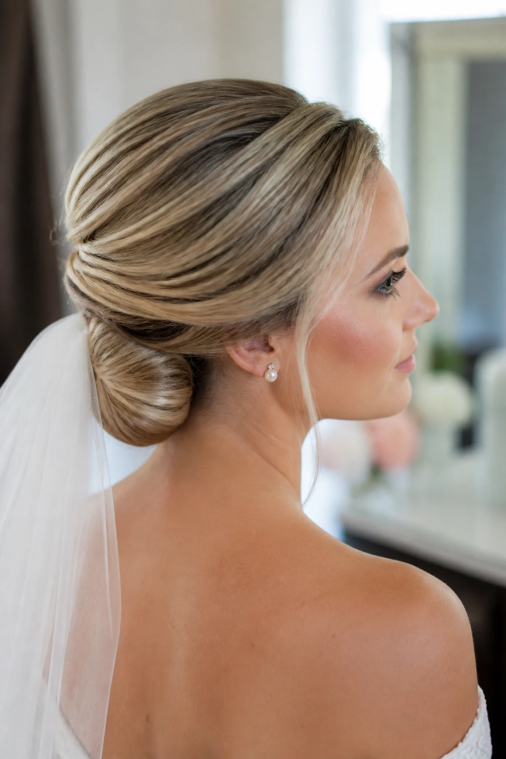 Close-up of a real bride with a Gibson tuck showing a smooth crown and tucked nape