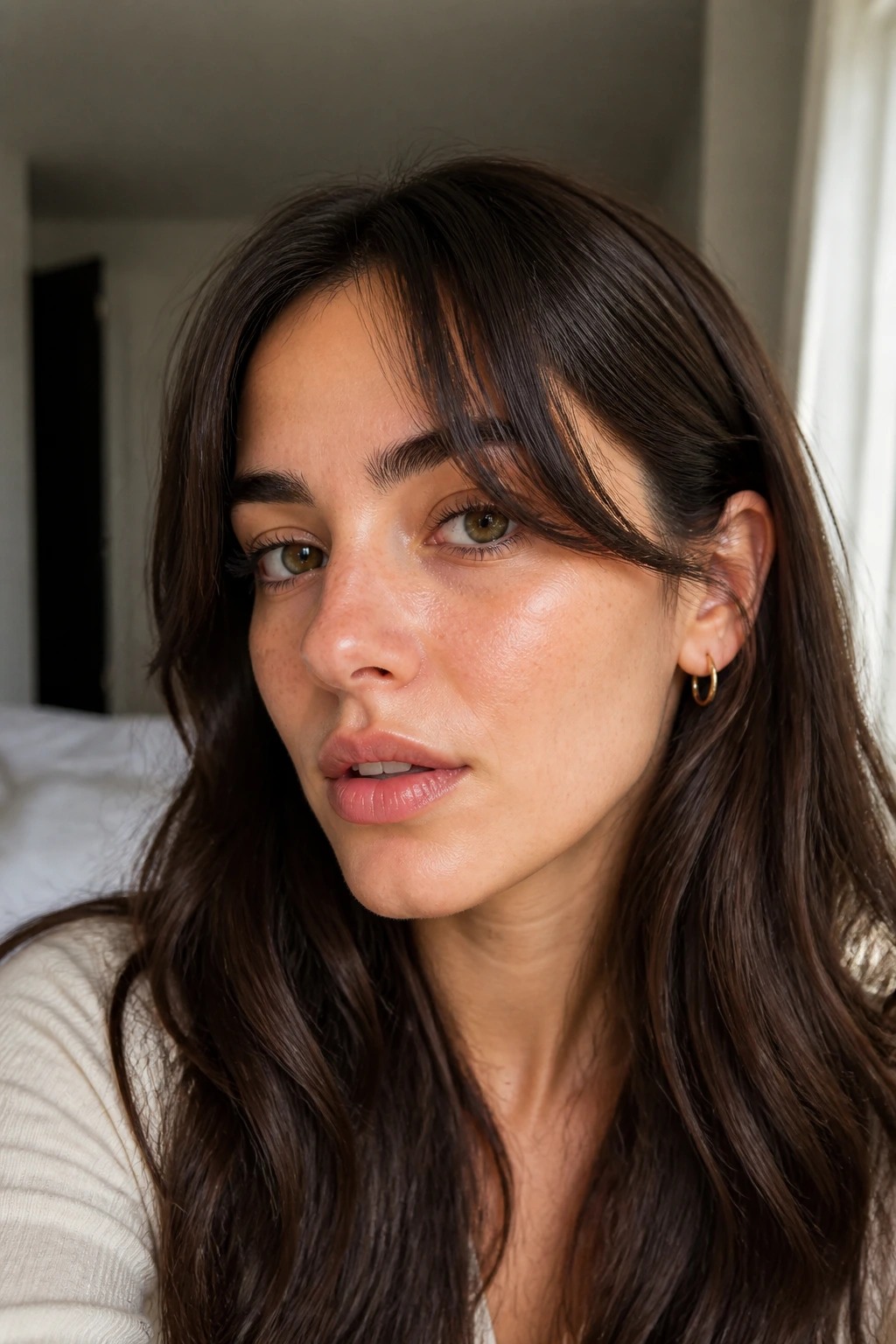 Close-up portrait of a real woman with grown-out bangs styled to look intentional