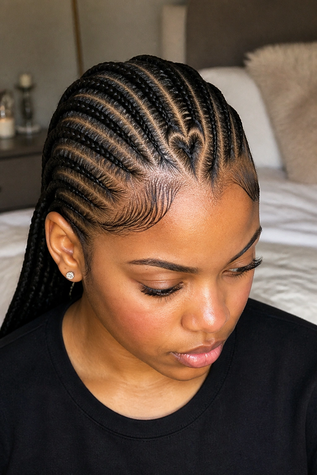 Portrait of a real person with a heart-shaped part in straight-back cornrows.
