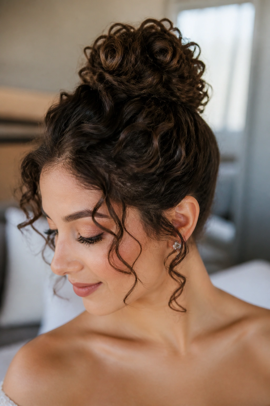 Close-up of a real person with a high top knot and soft ringlets