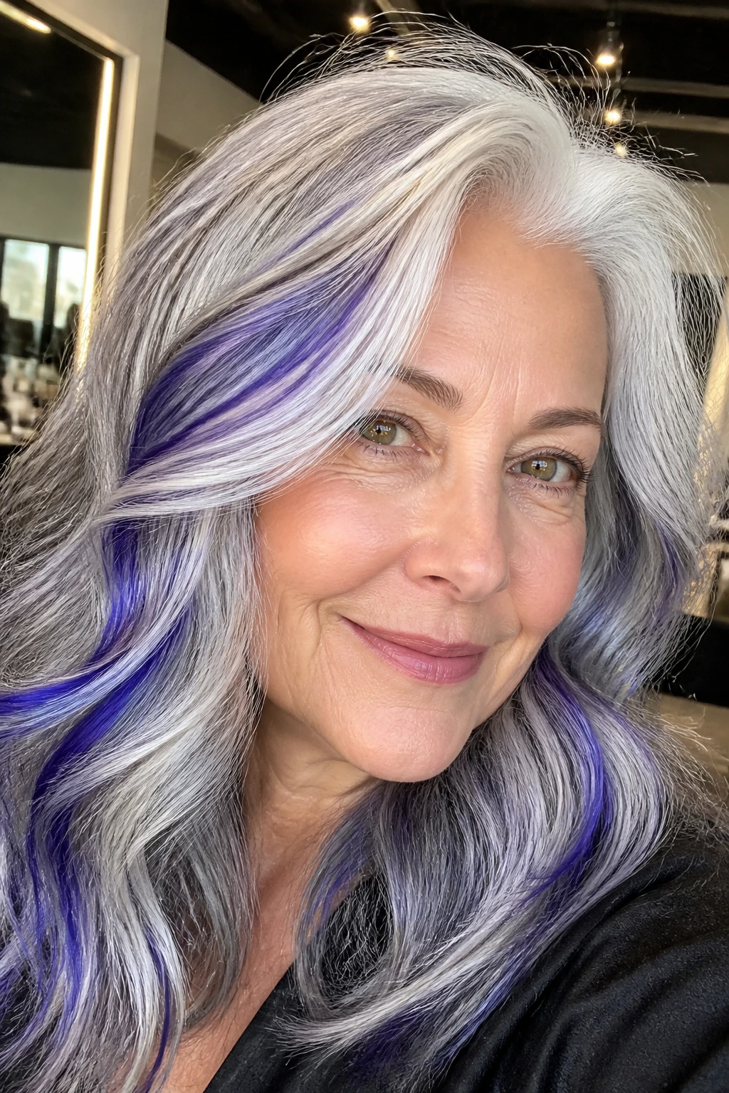 Close-up of silver hair with indigo accents on select strands